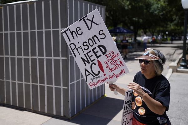 An advocate for cooling Texas prisons walks near the Texas Capitol.