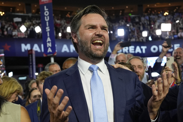 J.D. Vance smiles from the crowd on the floor of the Republican National Convention.