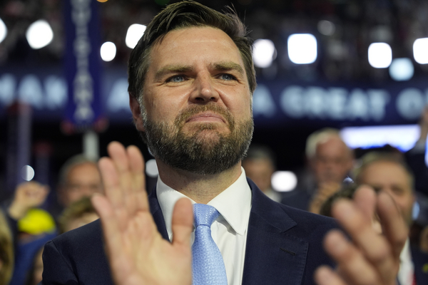 The GOP's vice presidential candidate, Ohio Sen. J.D. Vance, arrives on the floor during the first day of the 2024 Republican National Convention in Milwaukee. 